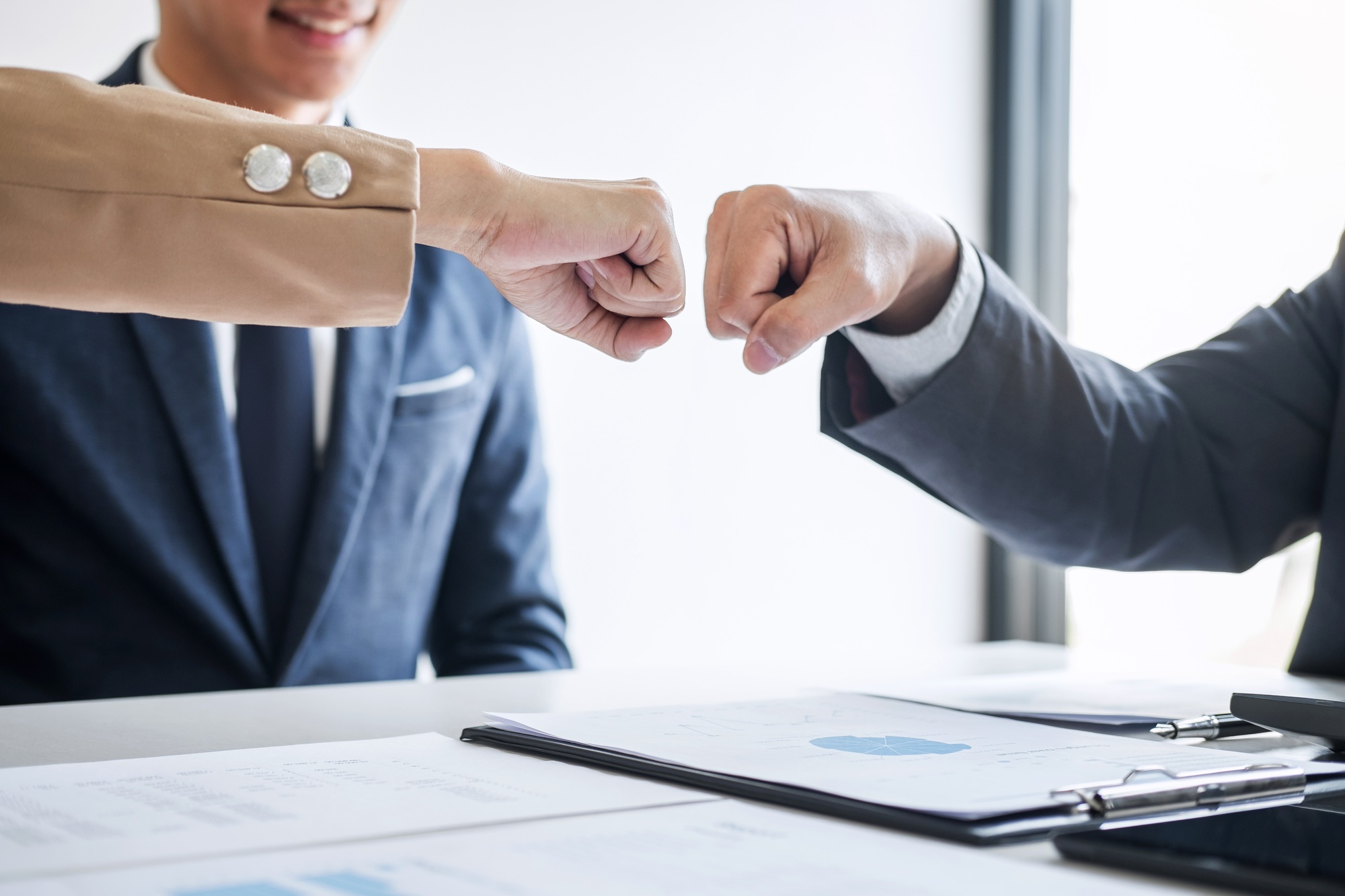 Teamwork of businessman partnership giving fist bump to greeting start up business strategy project